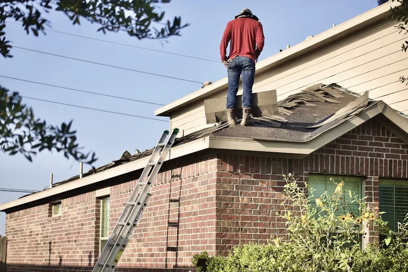 Professional roofer working on a residential roof in Truesdale Lake
